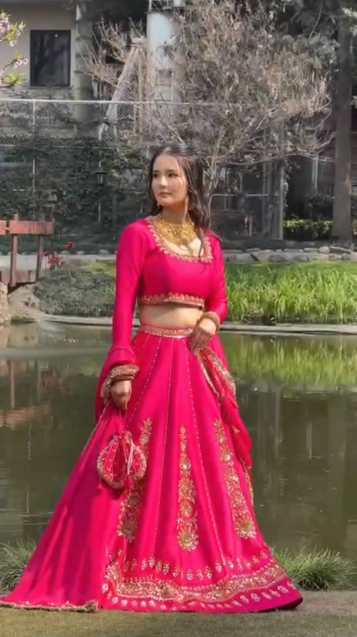 Radiant Rani Pink Silk Lehenga Choli Adorned with Opulent Heritage Floral Motifs and Intricate Zari Borders
